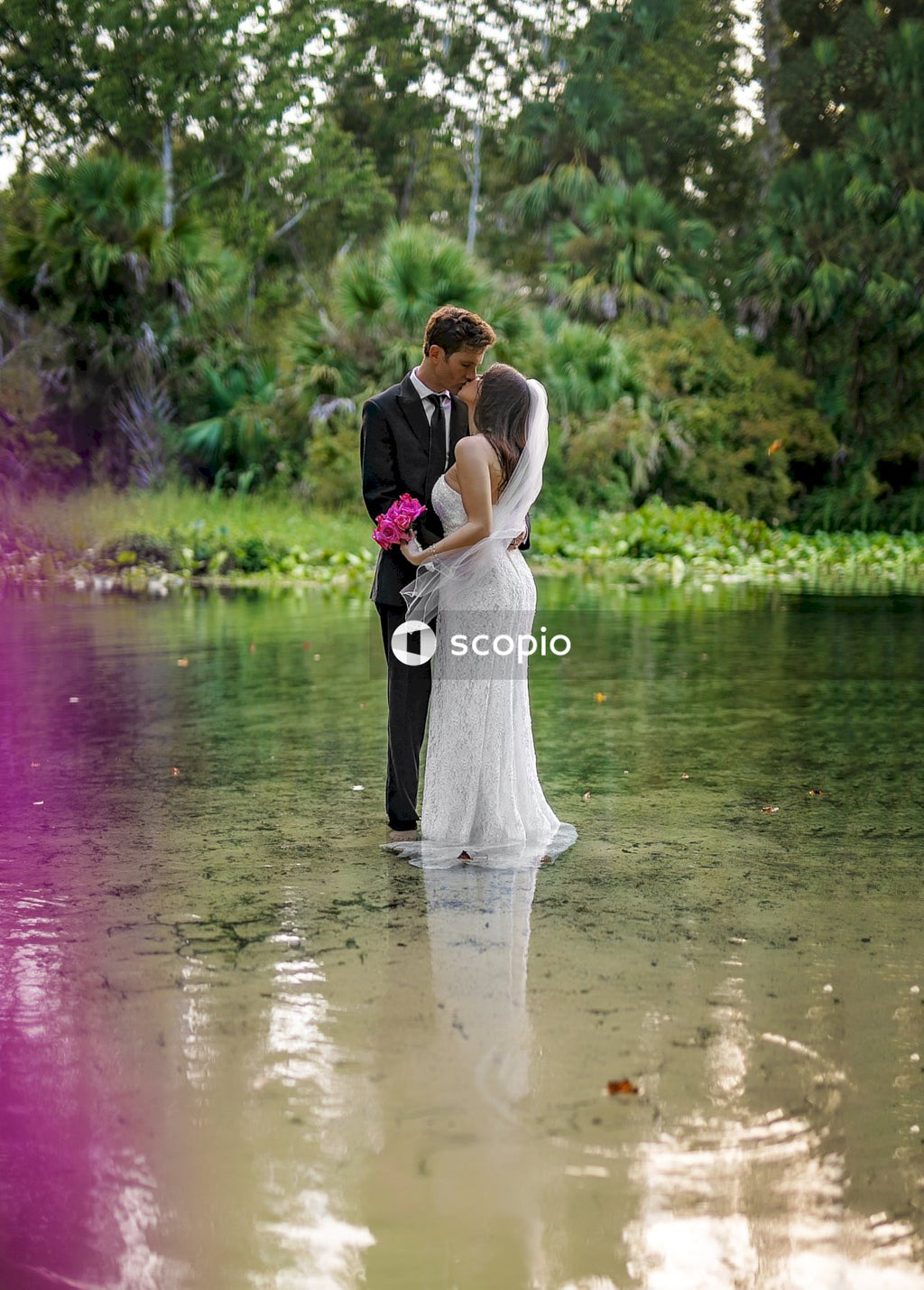 Bride and groom walking on river