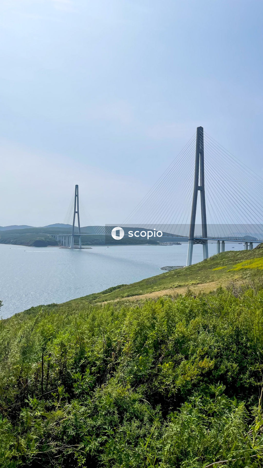 Bridge over river under cloudy sky