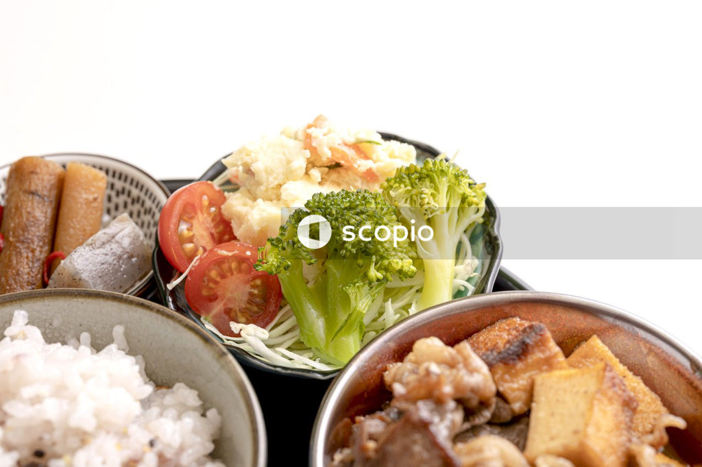 Broccoli and meat dish on white ceramic bowl