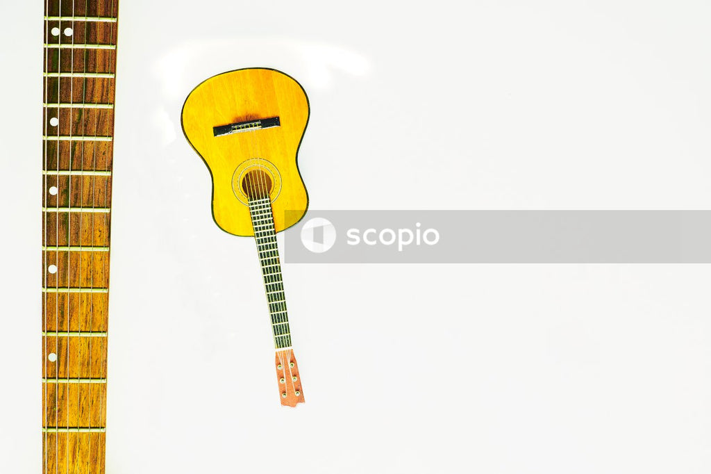 Brown acoustic guitar on white background