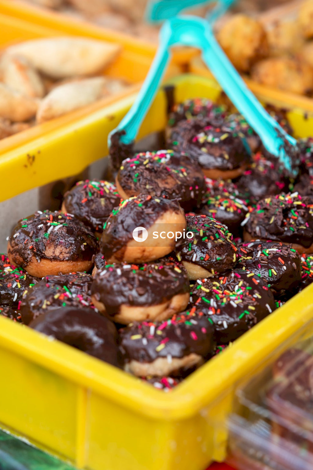 Brown and black food in yellow plastic container