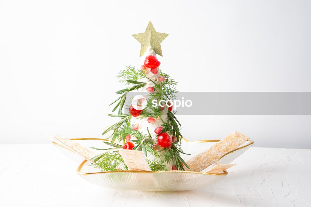 Brown and green christmas tree with baubles on white ceramic plate