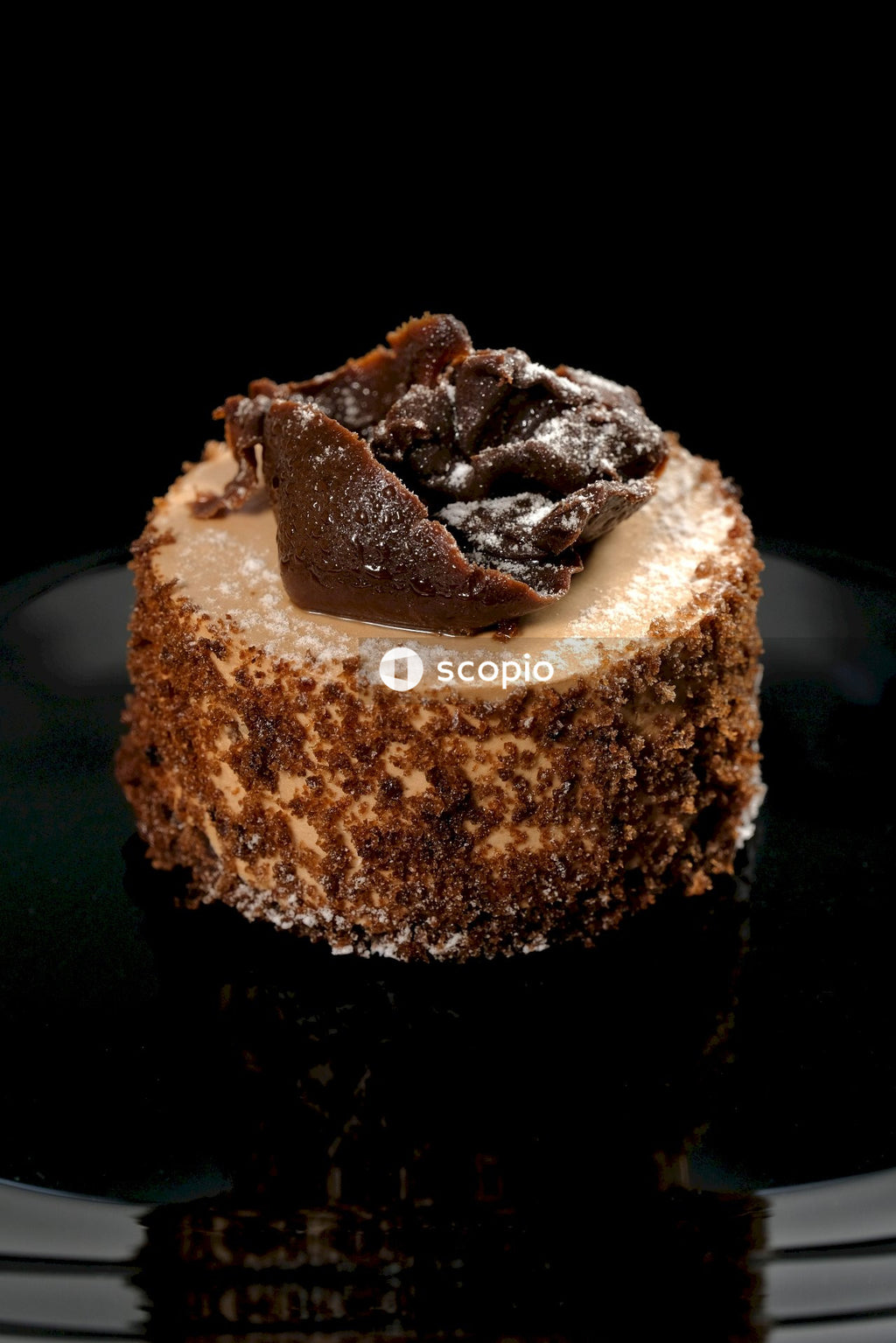 Brown and white cake on black surface