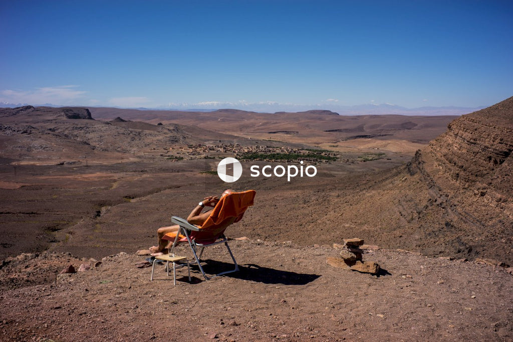 Brown and white camping chair on brown sand