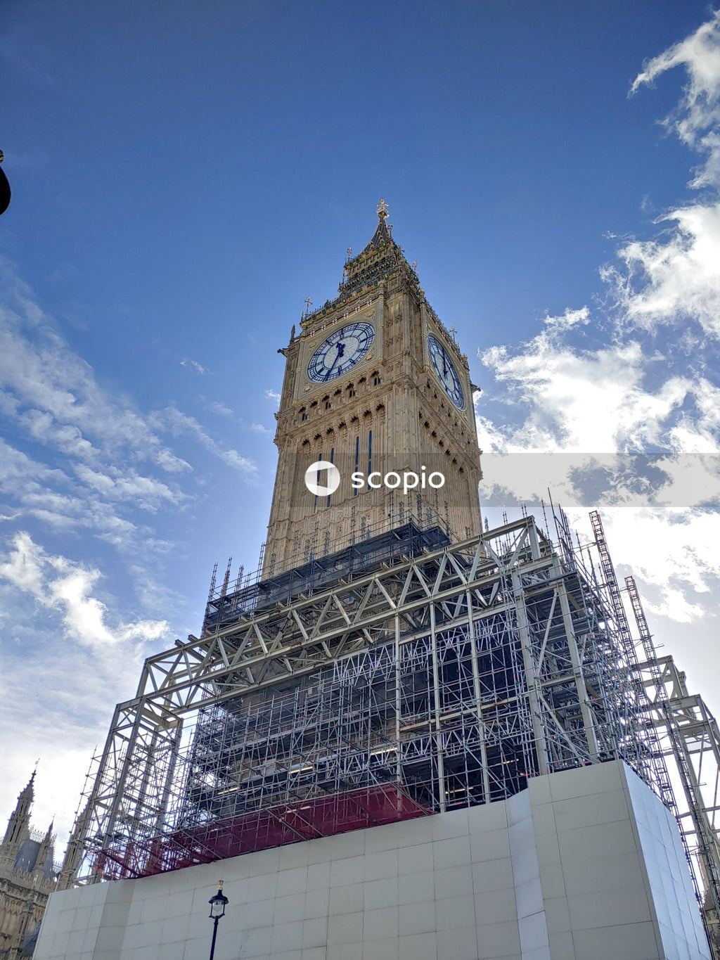 Brown and white clock tower under renovation