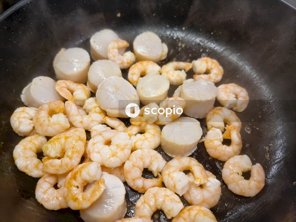 Brown and white food on black cooking pan