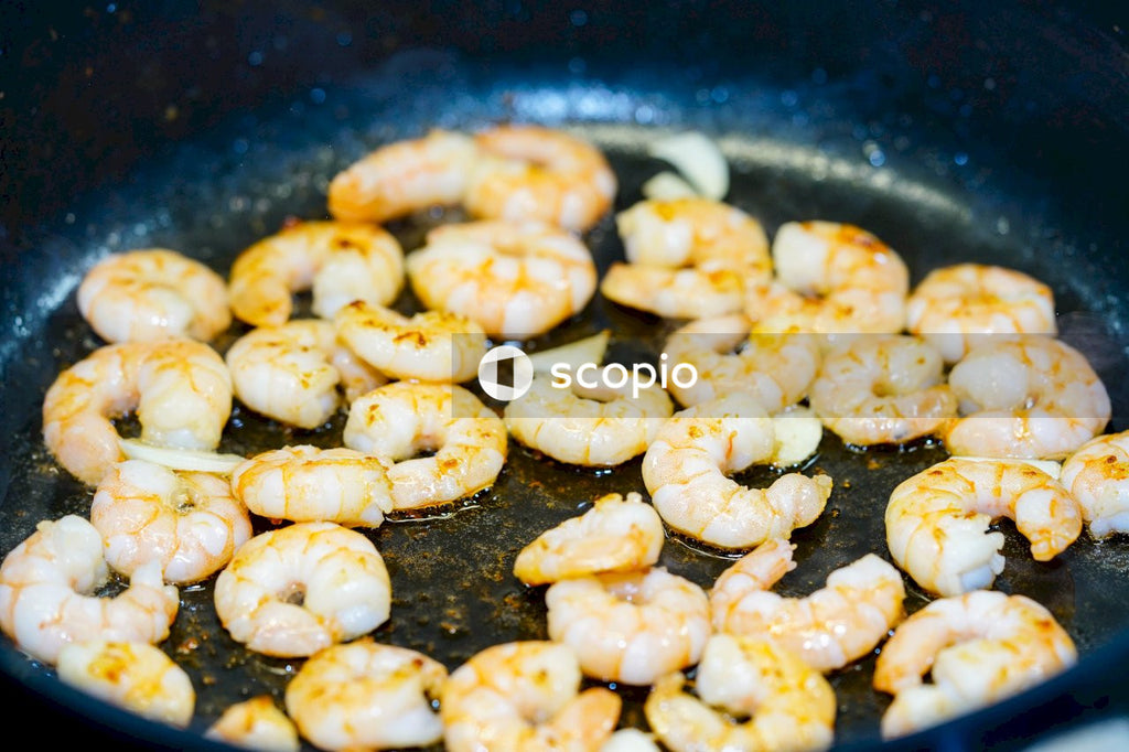 Brown and white fried food on black pan
