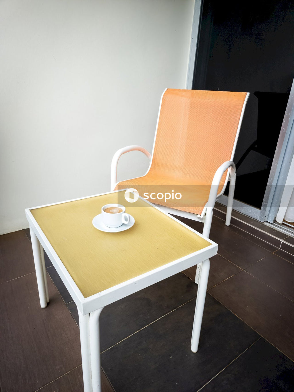 Brown and white padded chair beside brown wooden table