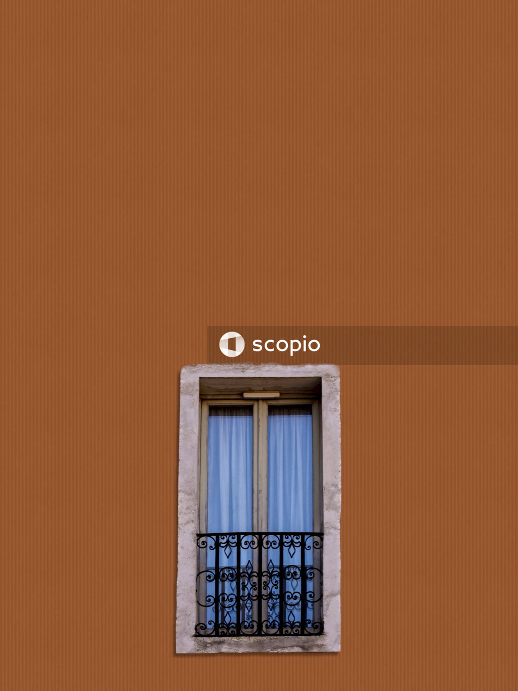Brown concrete building with blue wooden window