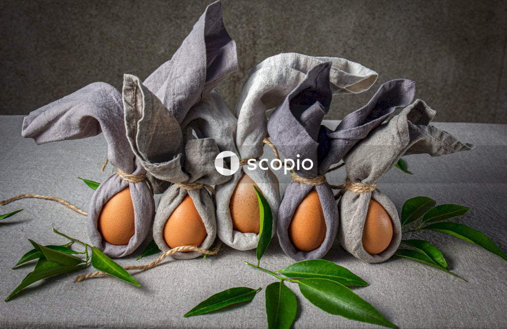 Brown egg on gray and white textile