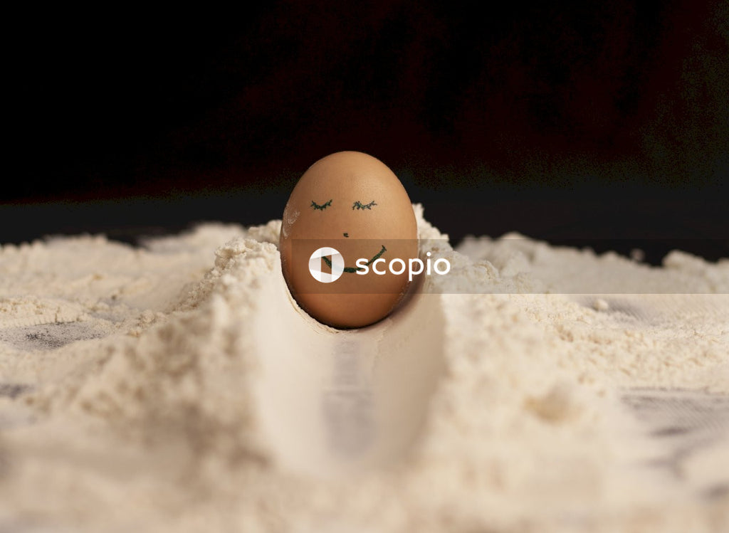 Brown egg on white powder