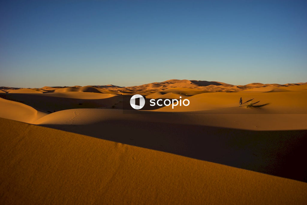 Brown sand field under blue sky