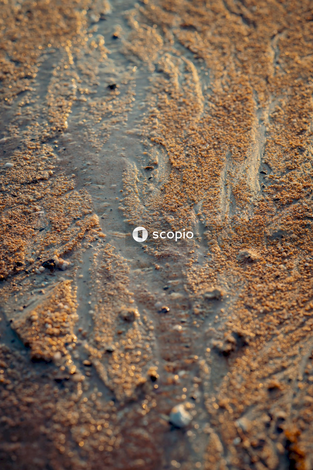 Brown sand with water droplets