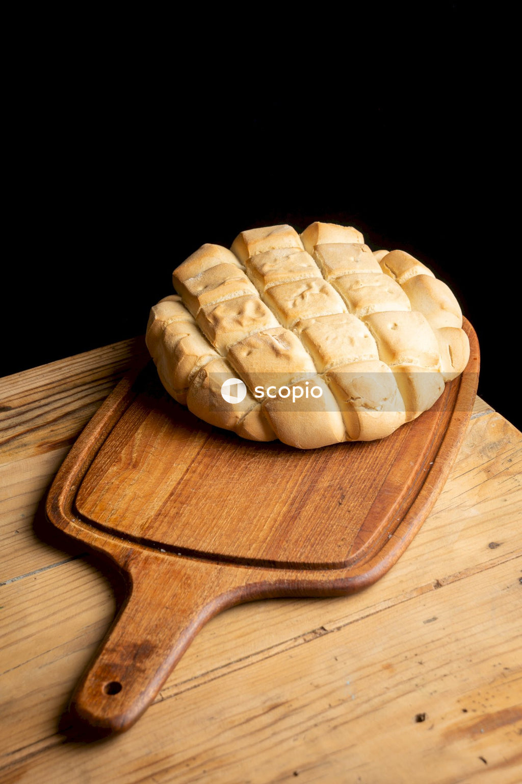 Brown wooden chopping board with cheese