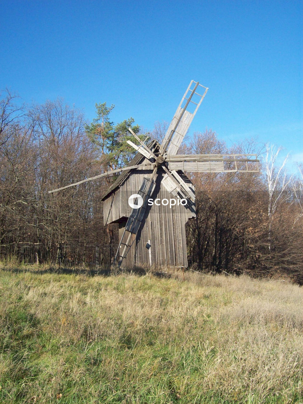 Brown wooden house on green grass field
