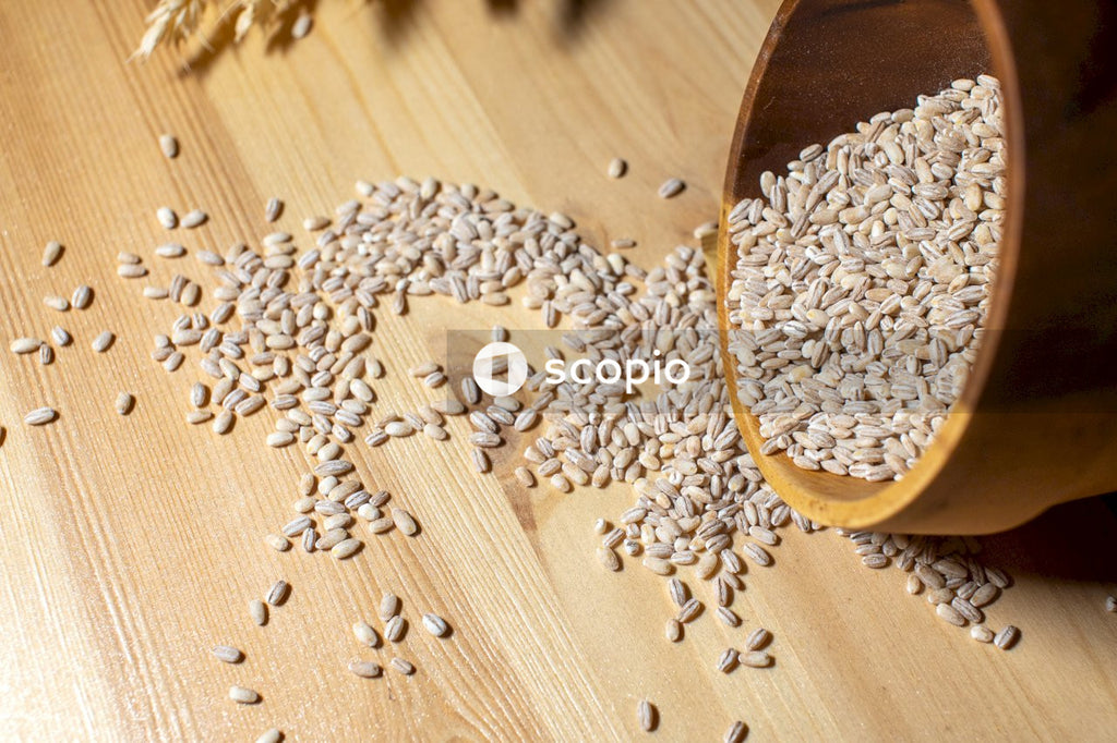 Brown wooden round bowl with white and black seeds