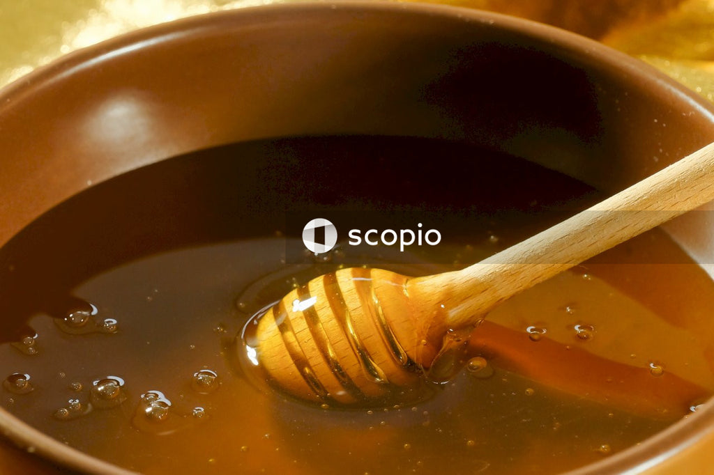 Brown wooden spoon on brown ceramic bowl