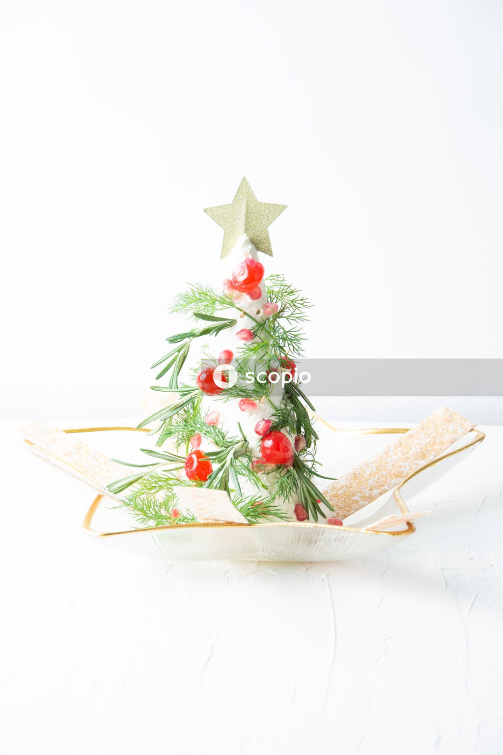 Brown wooden star ornament on white ceramic plate
