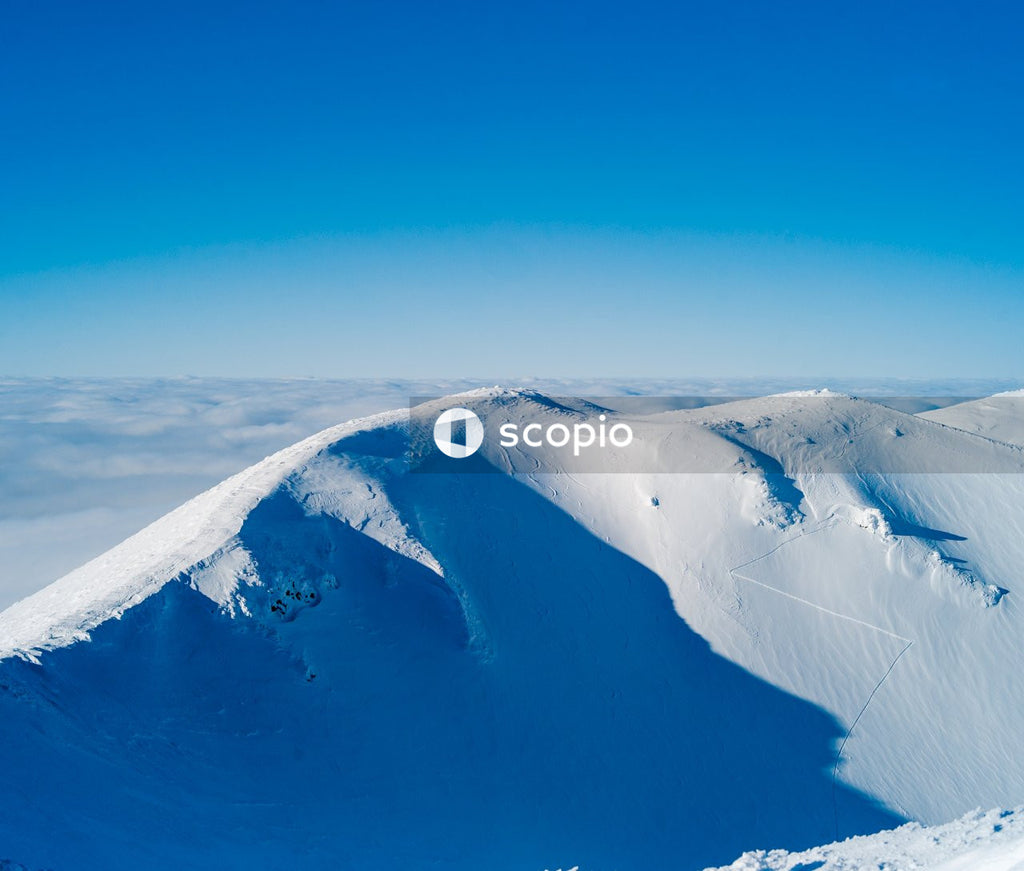 Snow covered mountain under blue sky