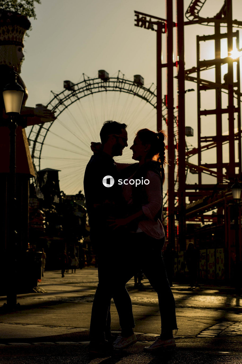 Silhouette of couple near the ferris wheel
