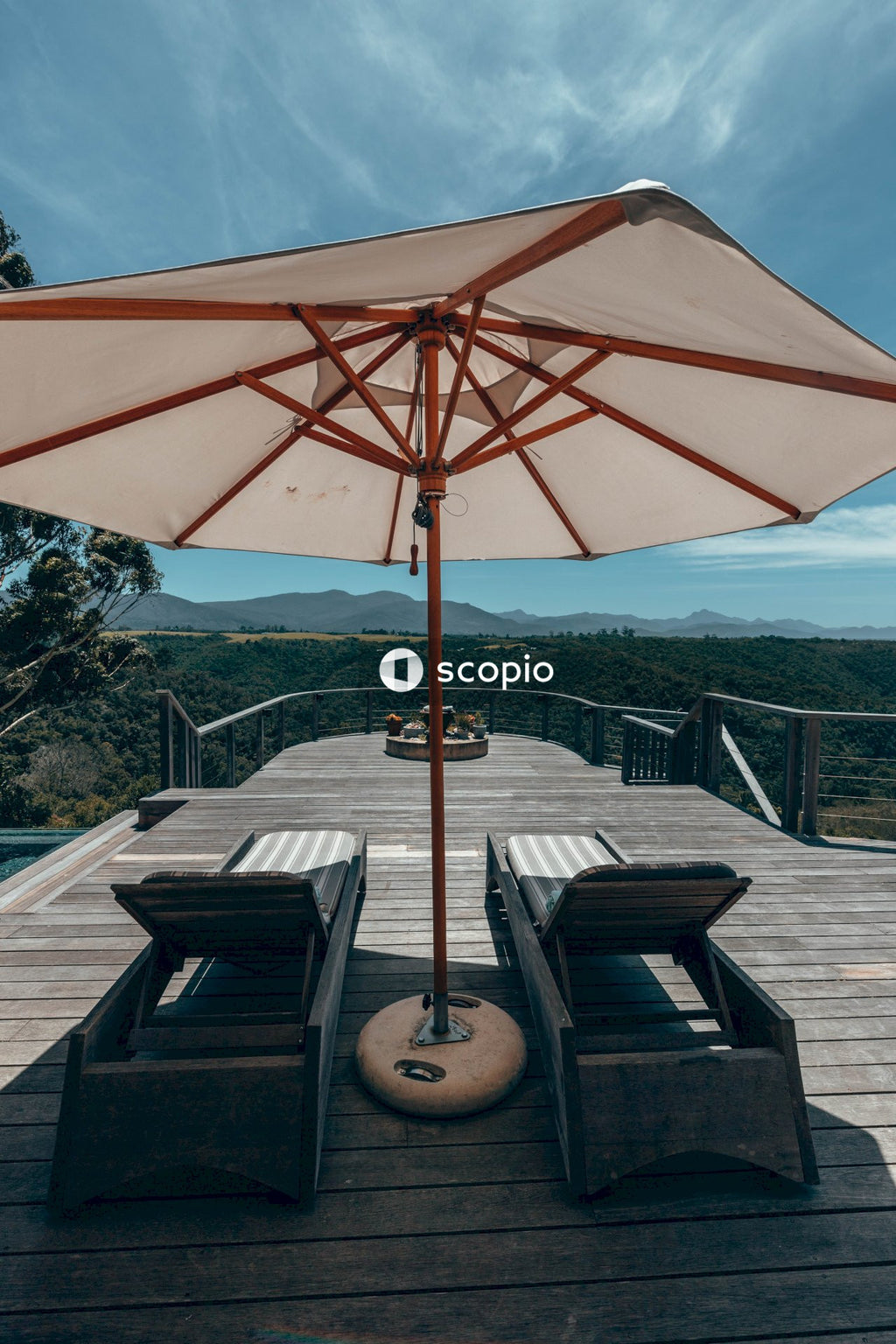 Red umbrella on brown wooden round table