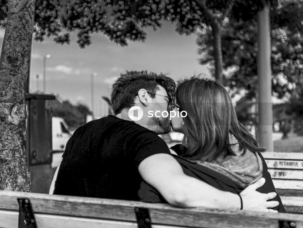 Man kissing womans forehead
