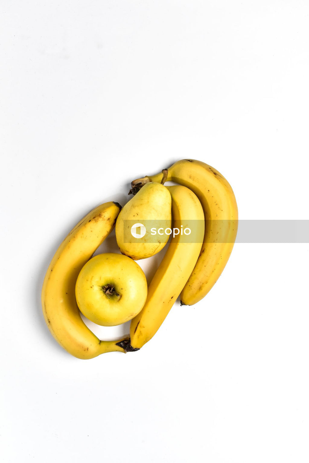 Yellow banana, pear and apple on white background