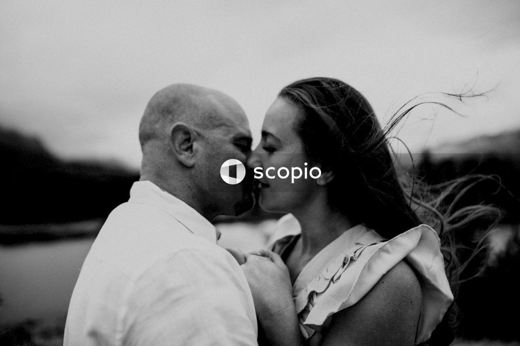 Man kissing womans forehead