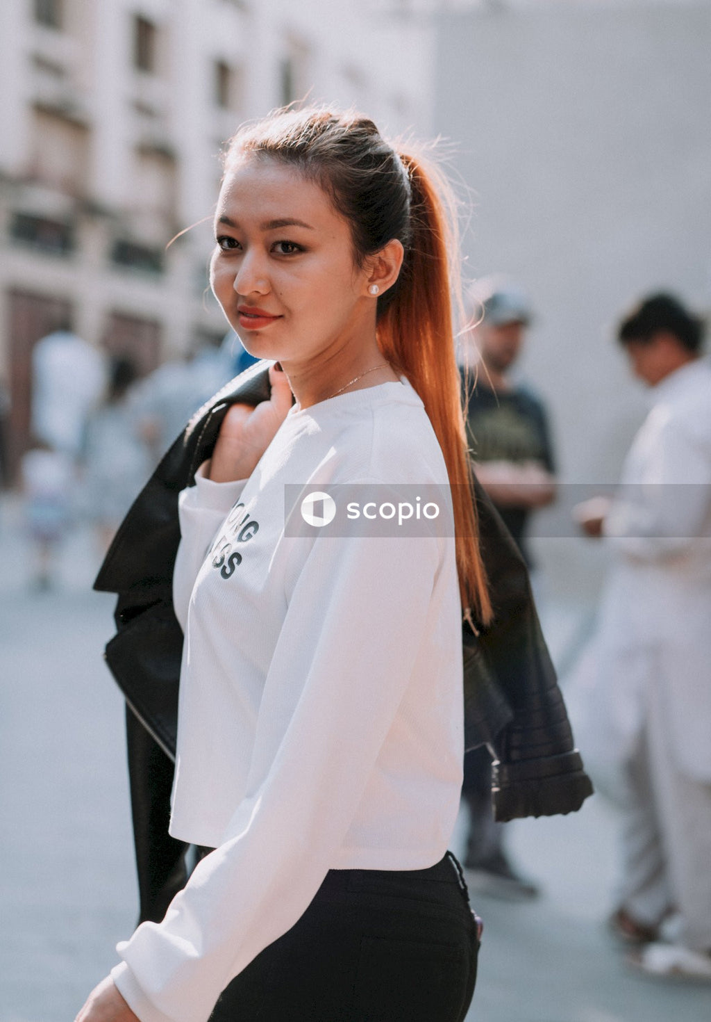 Woman in white crew neck shirt and black jacket