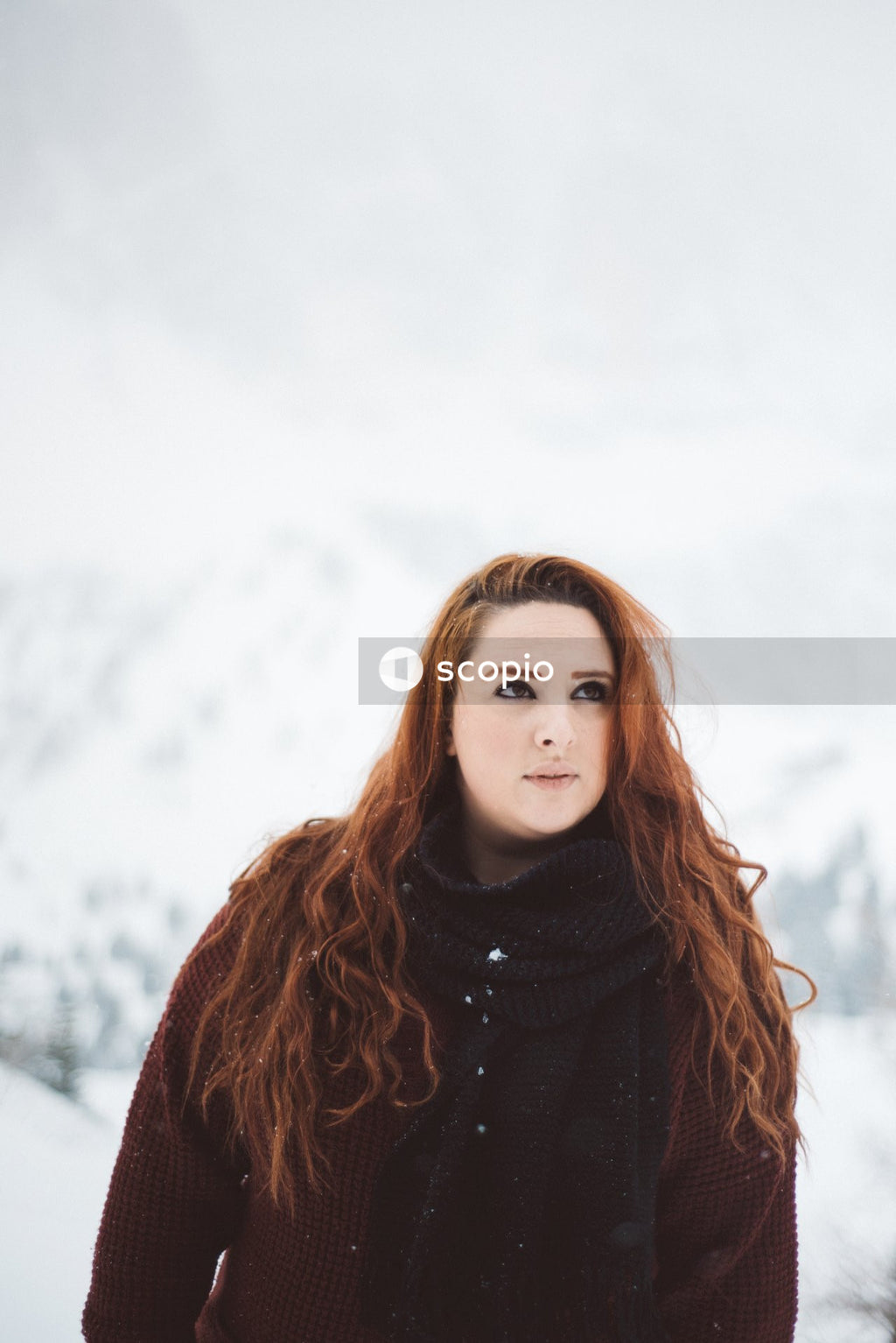 Woman in turtleneck sweater standing on snow