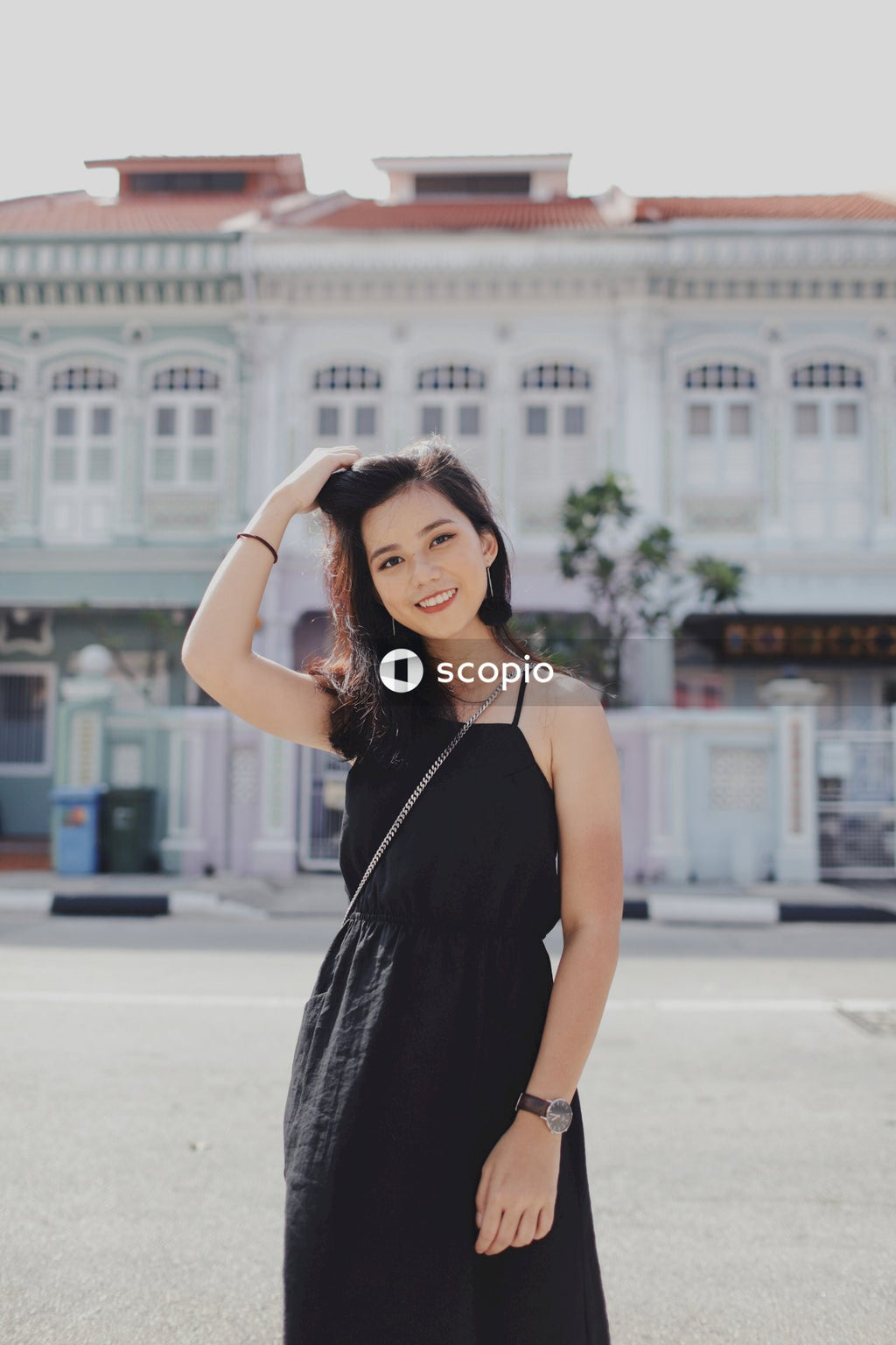 Woman on street posing near building