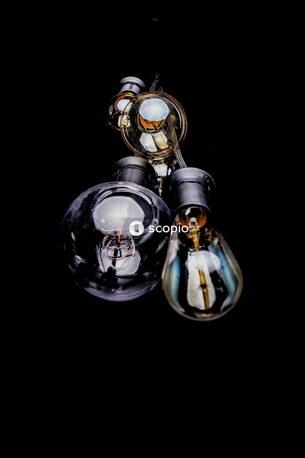 Clear glass light bulb with black background