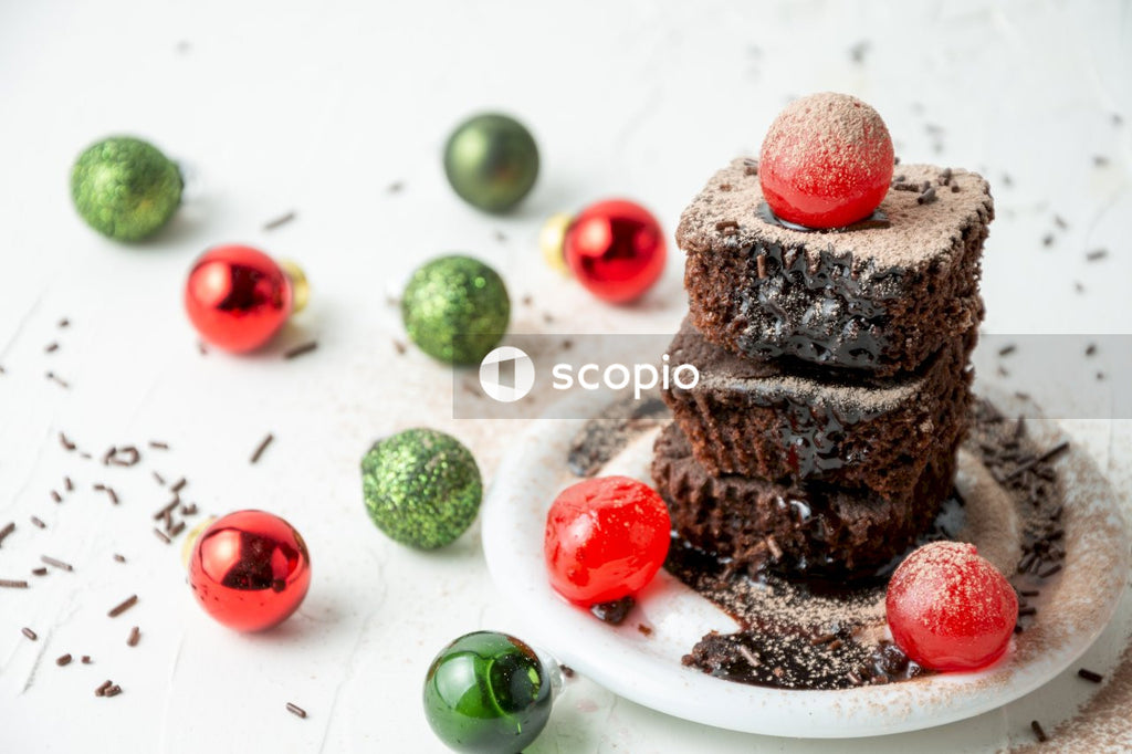 Chocolate cake with cherry on white ceramic plate