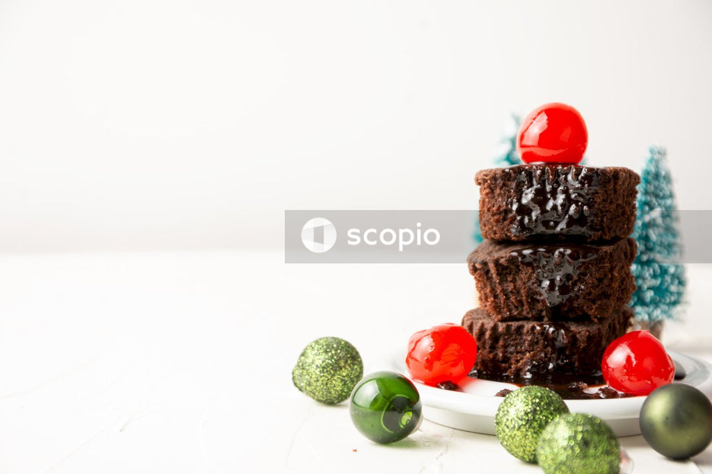 Chocolate cake with cherry on white ceramic plate