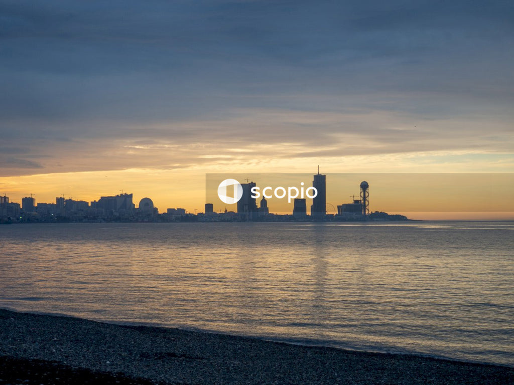 City skyline across body of water during sunset