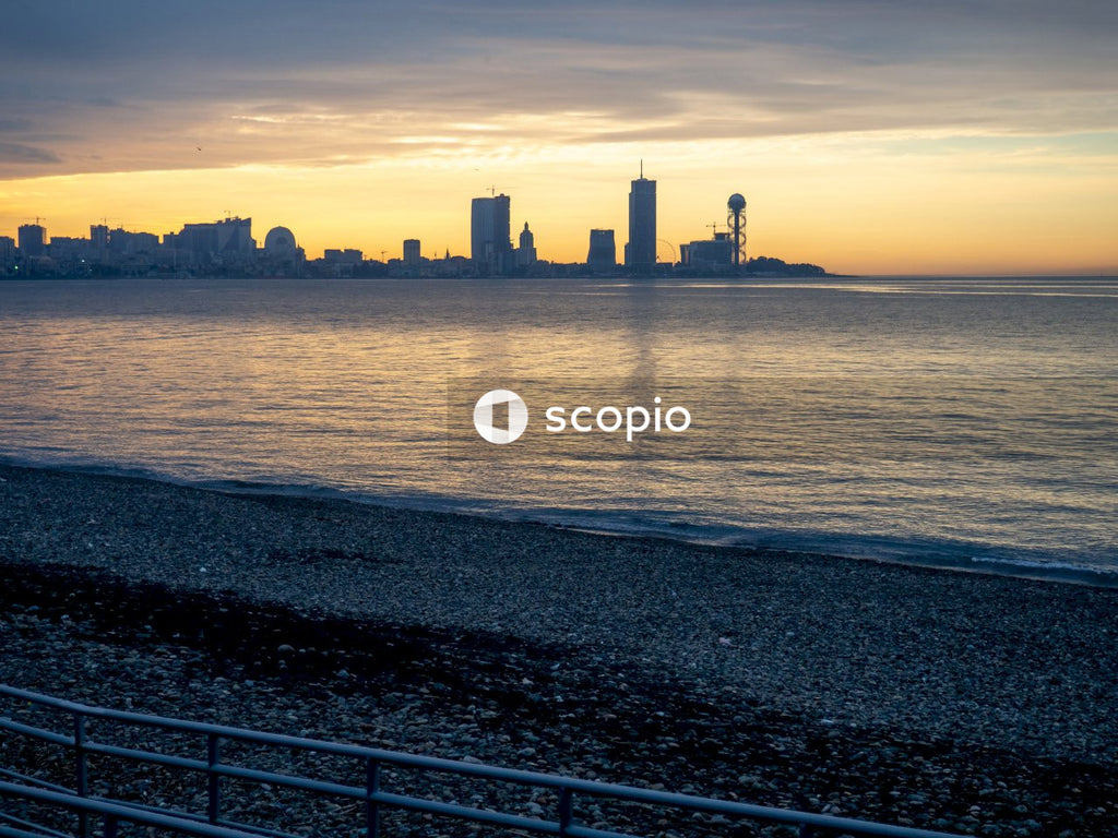 City skyline across the sea during sunset