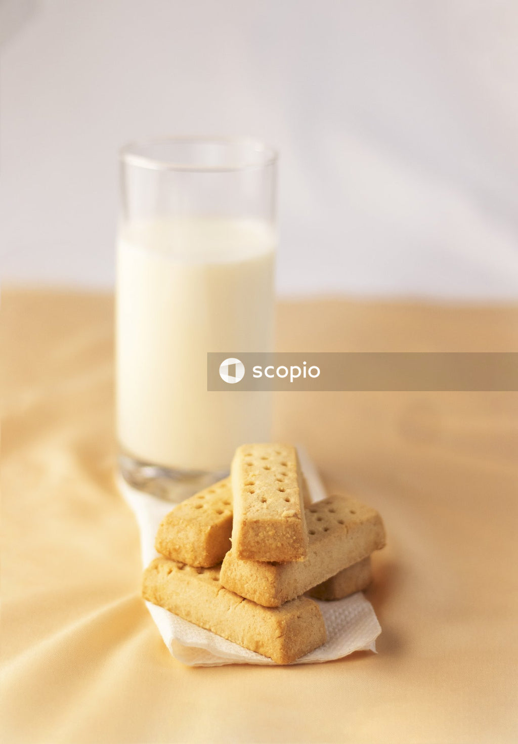 Clear drinking glass with milk and cookies