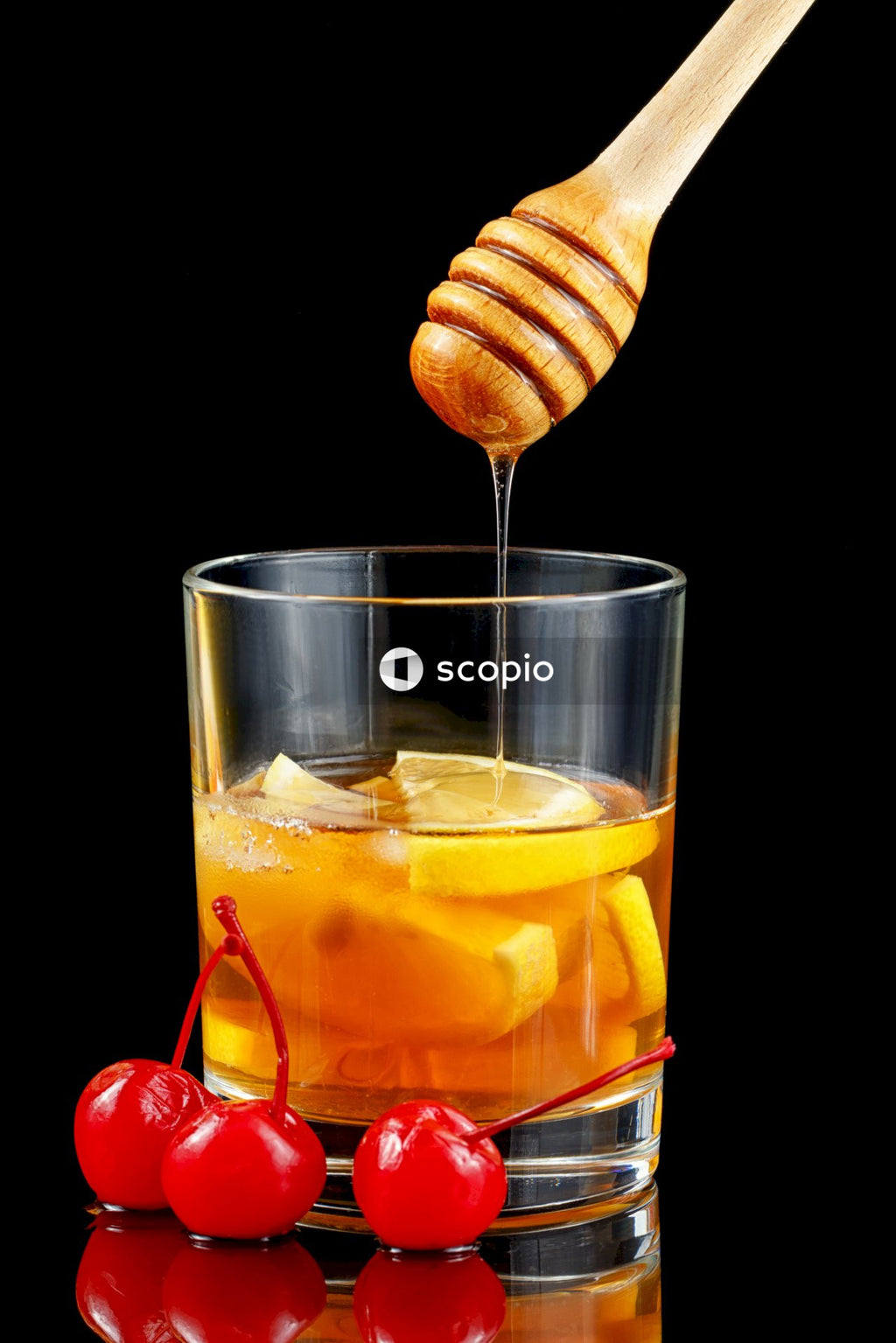 Clear drinking glass with yellow liquid