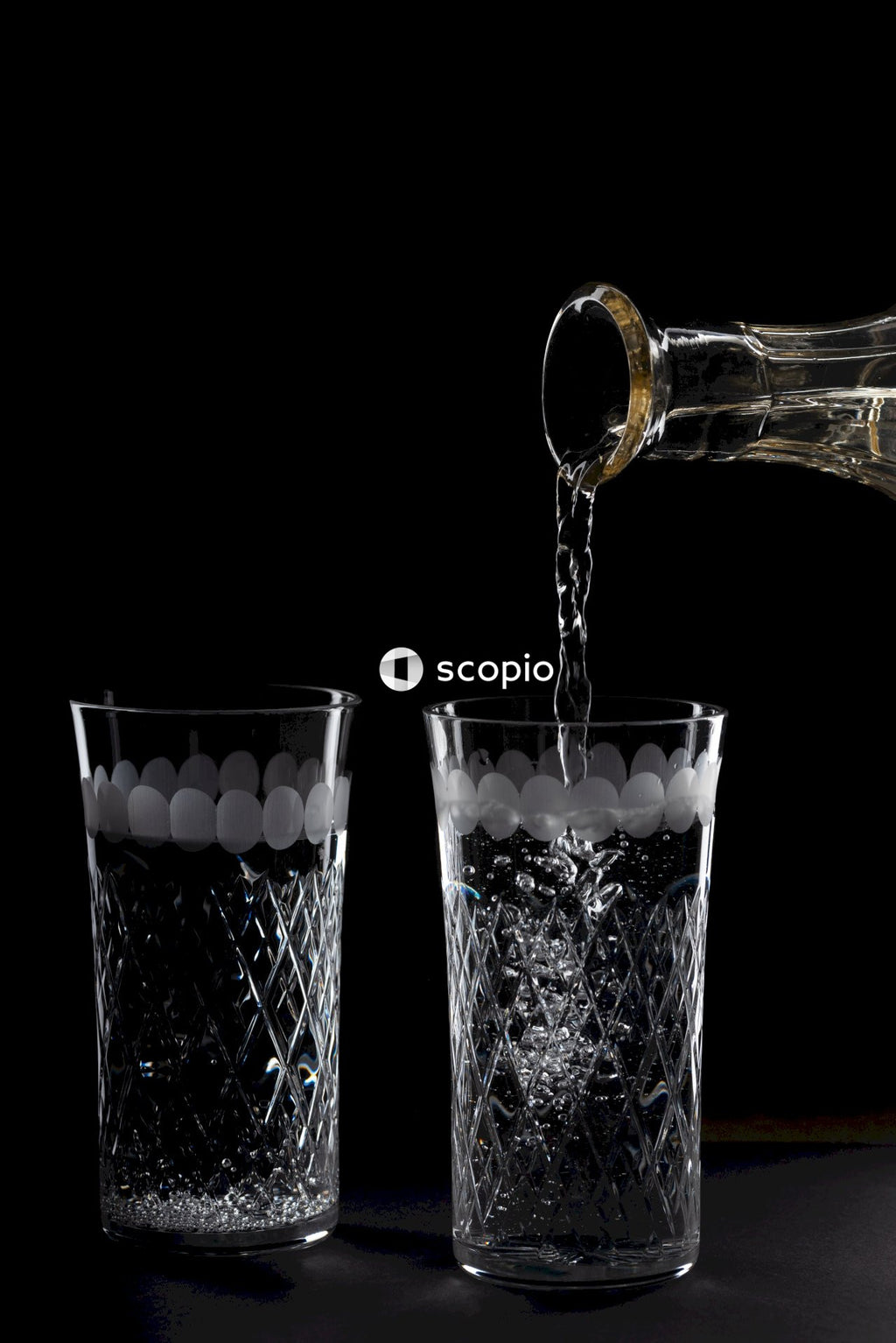 Clear glass bottle beside clear drinking glass