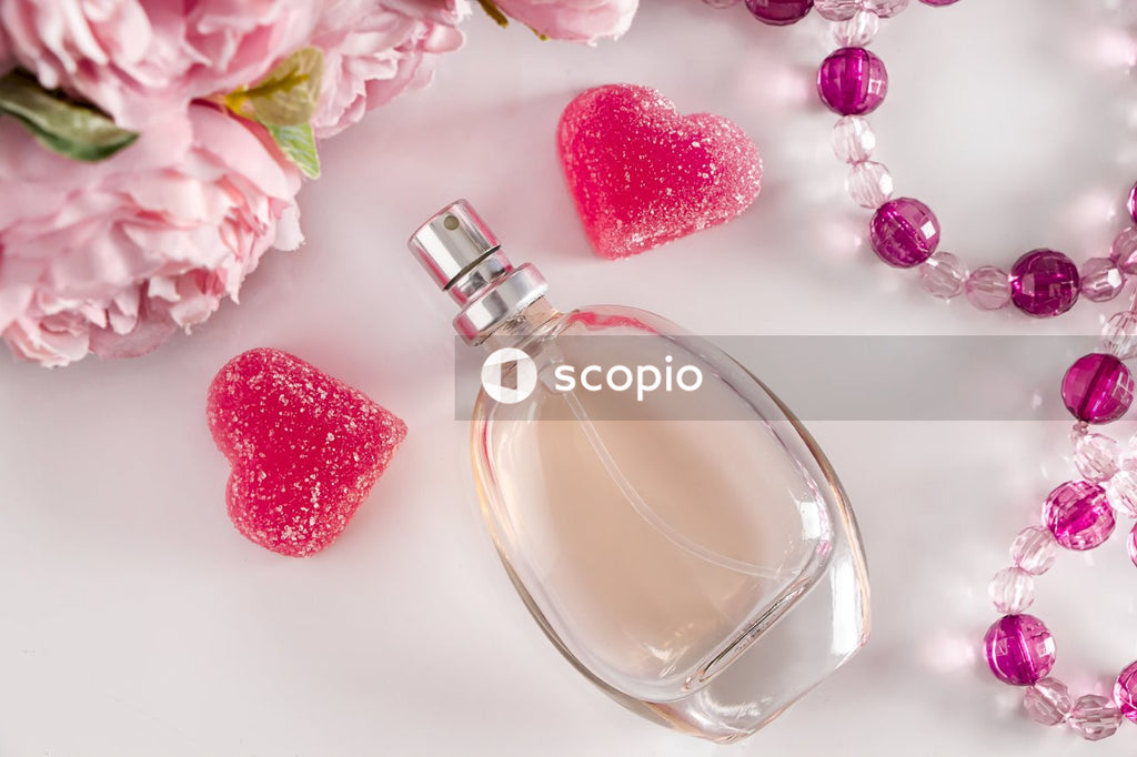 Clear glass bottle with red heart ornament