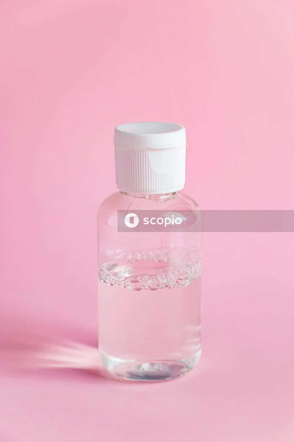 Clear glass bottle with white cap