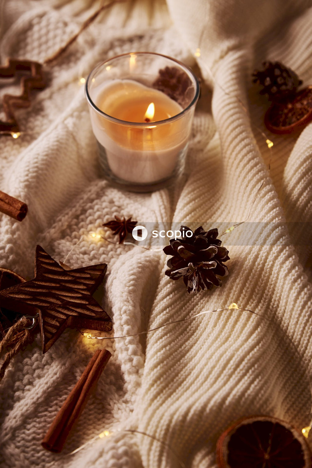 Clear glass cup with brown liquid on white table cloth