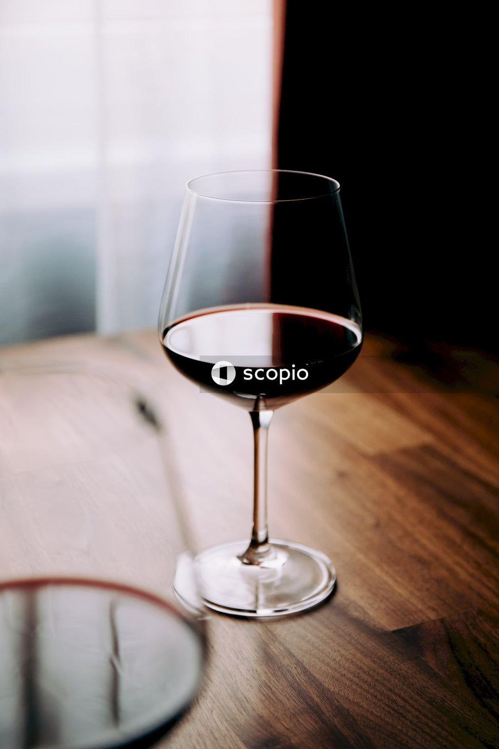 Clear wine glass on brown wooden table