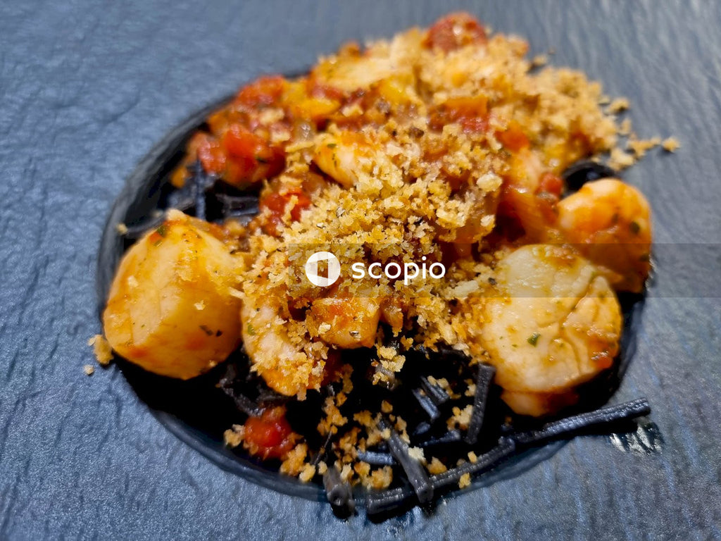 Cooked food on black ceramic plate