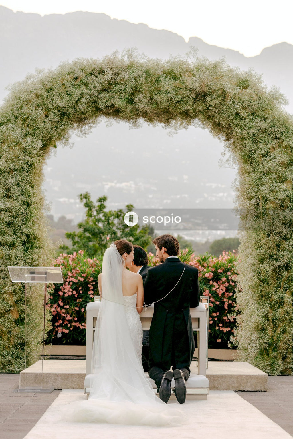 Couple kissing near green trees