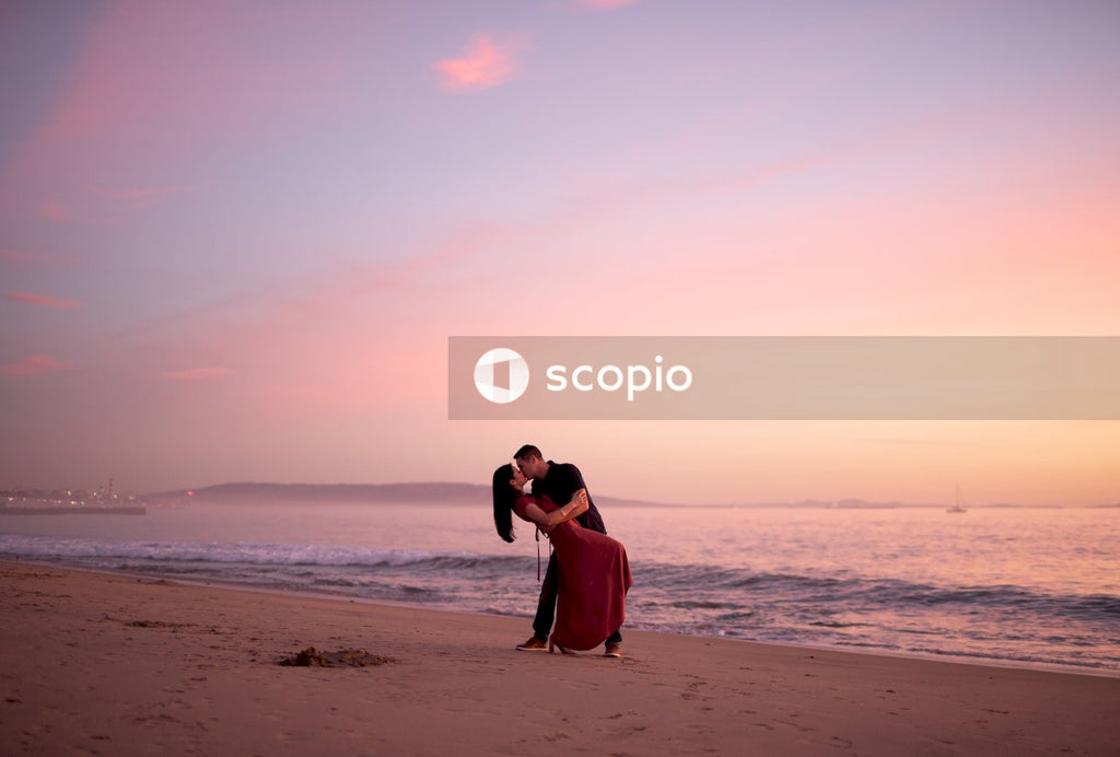 Couple kissing on beach during sunset