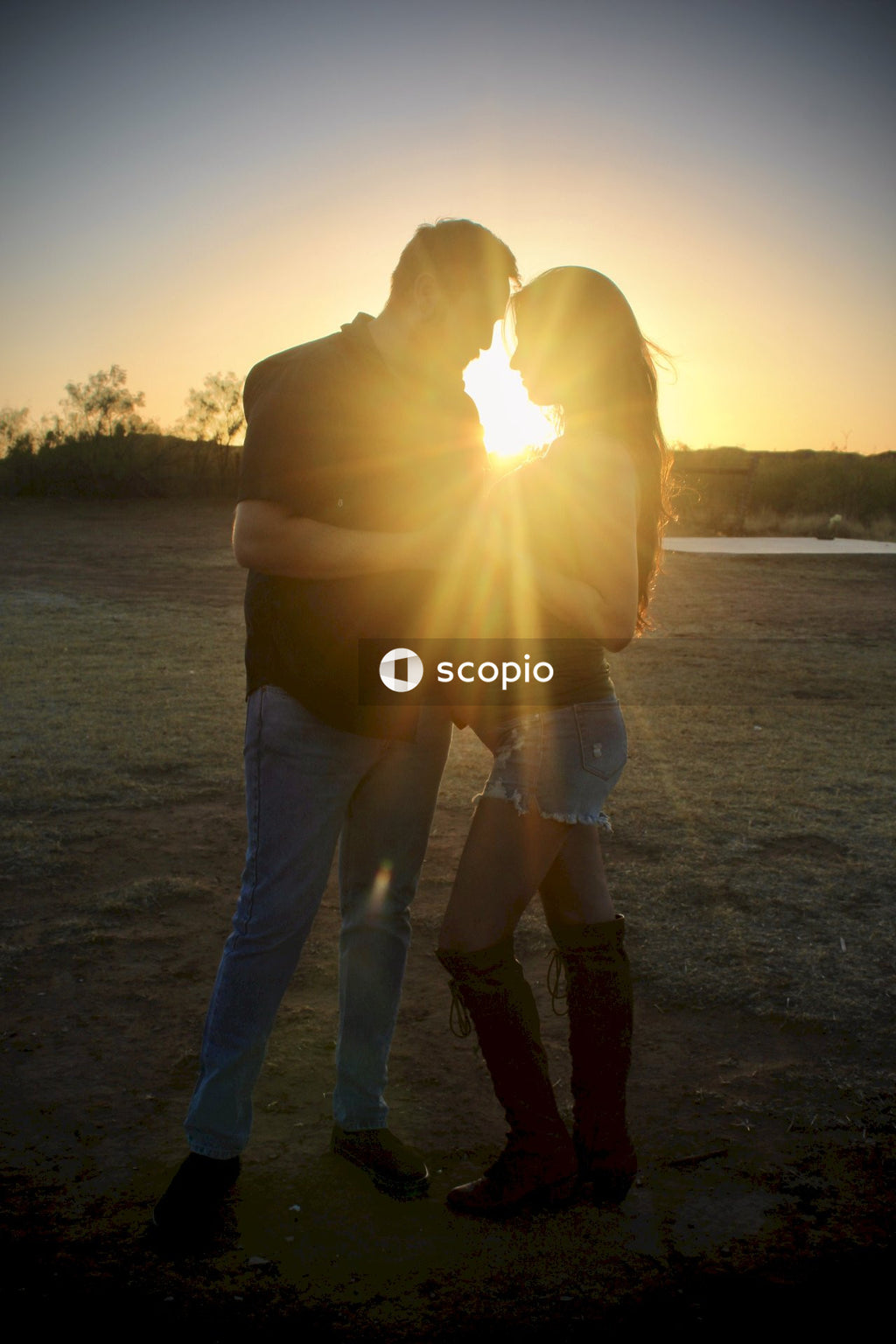 Couple kissing on beach during sunset