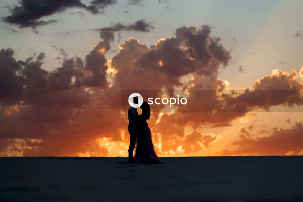 Couple kissing on beach during sunset