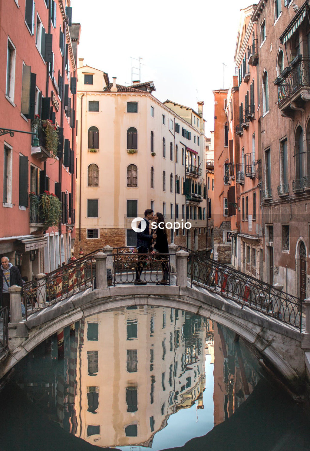 Couple kissing on bridge over Grand Canal, Venice