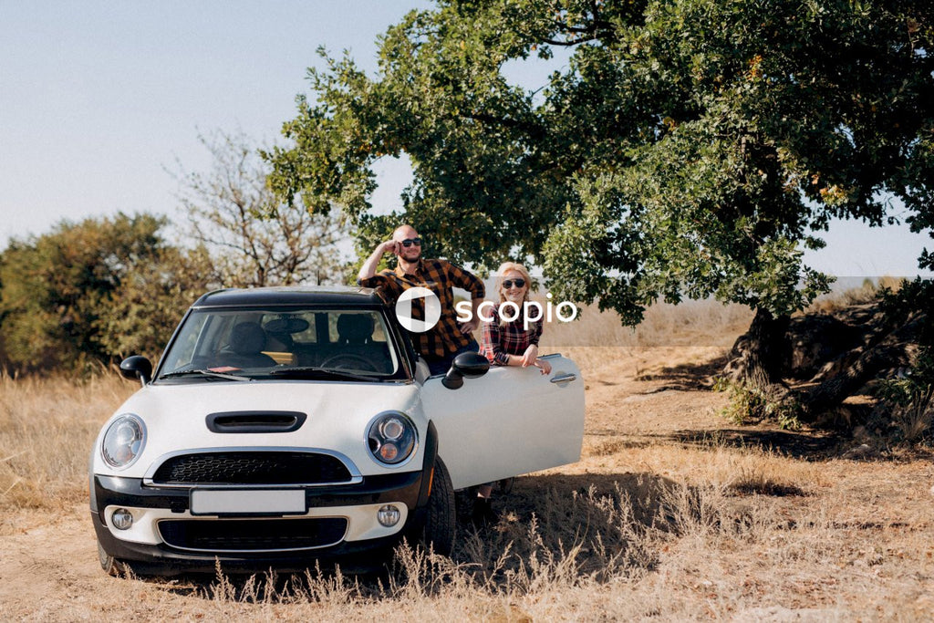 Couple kissing on white car